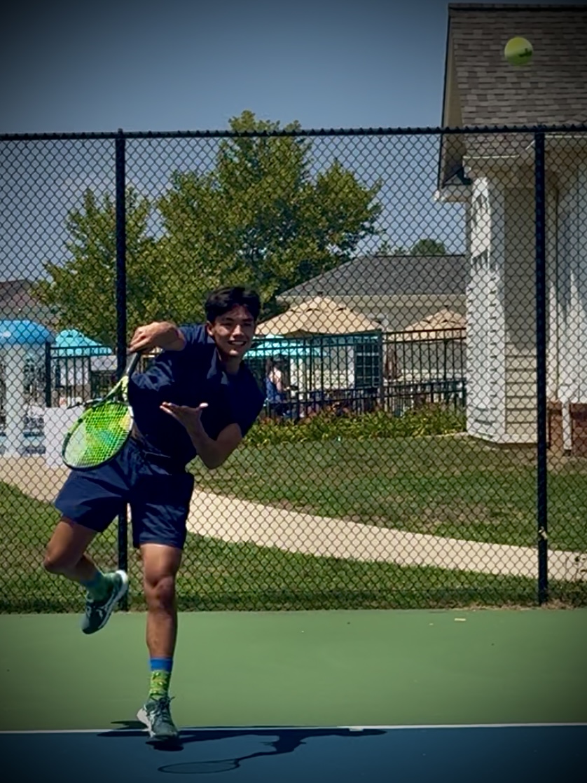 Judah Wang serving on the tennis court